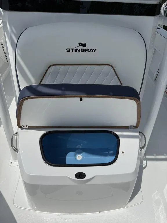 Slide: The Image of 2025 Stingray 216CC boat interior with open storage compartment, showcasing sleek design and functionality. - 24