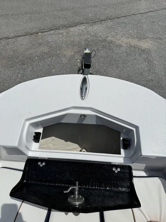 Slide: The Image of 2025 Stingray 216CC boat deck with storage compartment and latch. - 25