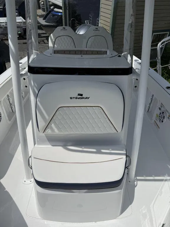 Slide: The Image of 2025 Stingray 216CC boat interior with sleek white seating and modern design. - 26