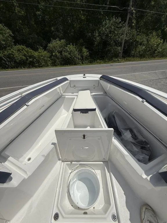 Slide: The Image of 2025 Stingray 216CC boat interior with open storage compartments and seating. - 27