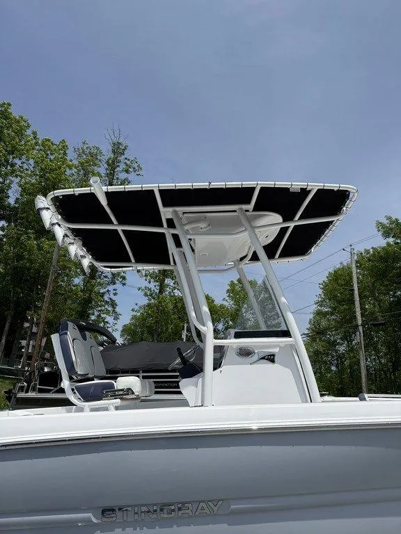 Slide: The Image of 2025 Stingray 216CC boat with T-top, sleek design, and modern features. - 4