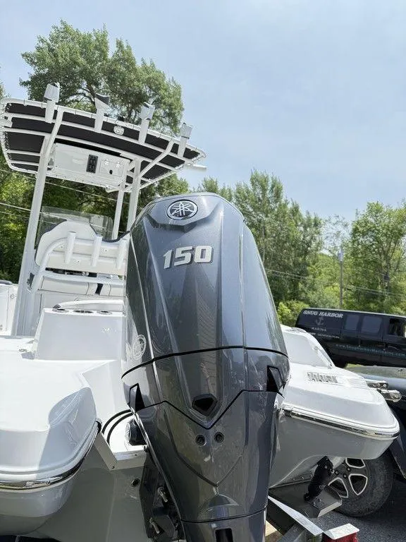 Slide: The Image of 2025 Stingray 216CC boat with 150 horsepower engine, parked outdoors. - 6