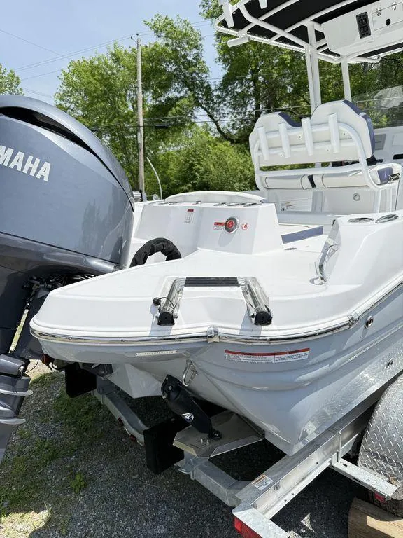 Slide: The Image of 2025 Stingray 216CC boat with Yamaha engine, parked outdoors on a trailer. - 8