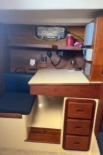 Slide: The Image of Interior of 1987 Morgan Catalina Morgan 41 Classic sailboat with cozy seating and wooden cabinetry. - 24