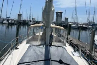 Slide: The Image of 1987 Morgan Catalina Morgan 41 Classic sailboat docked at marina, covered deck, calm waters. - 3
