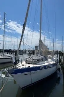 Slide: The Image of 1987 Morgan Catalina Morgan 41 Classic sailboat docked at marina with blue sky. - 4