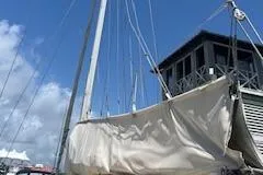 Slide: The Image of 1987 Morgan Catalina Morgan 41 Classic sailboat deck with canopy and ropes at marina. - 7