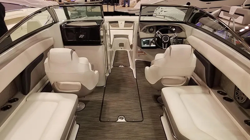 Slide: The Image of Interior of 2018 Four Winns HD270 OB boat with white seating and modern dashboard. - 15