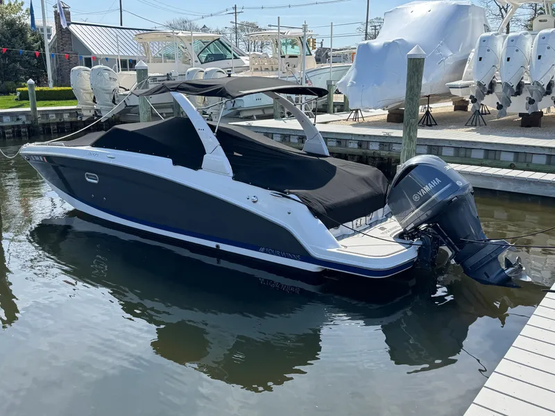 Slide: The Image of 2018 Four Winns HD270 OB boat docked with Yamaha outboard motor. - 2