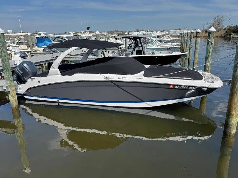 Slide: The Image of 2018 Four Winns HD270 OB boat docked at marina, covered and ready for use. - 3