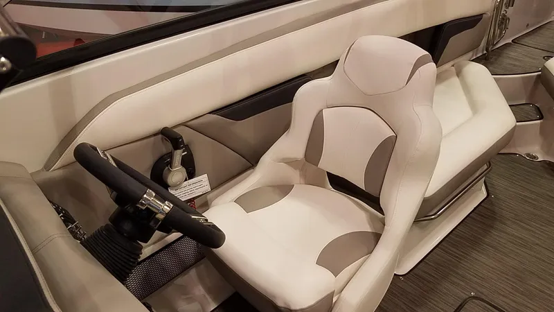 Slide: The Image of 2018 Four Winns HD270 OB boat interior with steering wheel and cushioned seat. - 8
