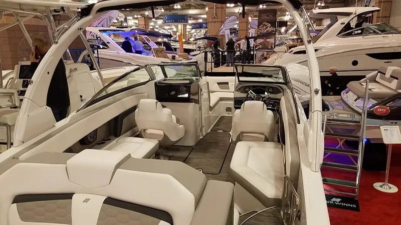 Slide: The Image of 2018 Four Winns HD270 OB boat interior at a boat show, featuring luxurious seating and modern design. - 9