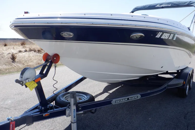 Slide: The Image of 2014 Hurricane SunDeck Sport 203 OB boat on trailer, parked outdoors. - 11