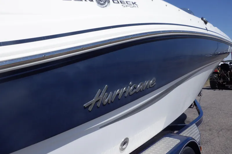 Slide: The Image of 2014 Hurricane SunDeck Sport 203 OB boat with sleek blue and white design. - 13