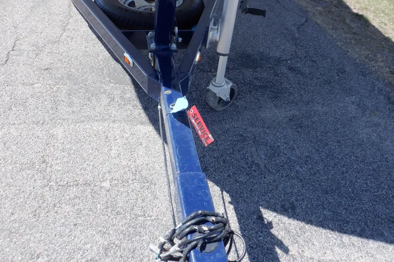 Slide: The Image of Trailer hitch of a 2014 Hurricane SunDeck Sport 203 OB on asphalt pavement. - 22