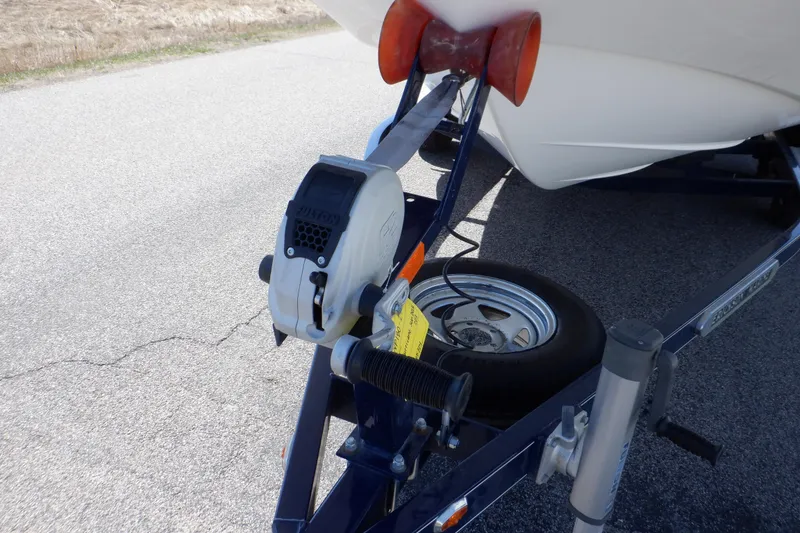 Slide: The Image of 2014 Hurricane SunDeck Sport 203 OB boat on trailer, featuring winch and spare tire. - 23