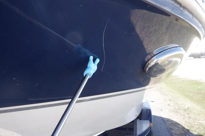 Slide: The Image of 2014 Hurricane SunDeck Sport 203 OB boat with a visible scratch on the hull. - 26