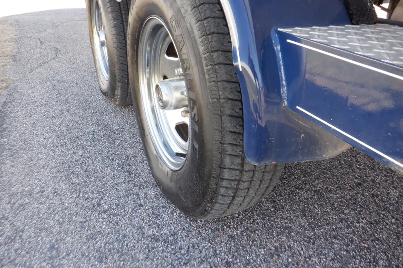 Slide: The Image of Trailer wheels of a 2014 Hurricane SunDeck Sport 203 OB on asphalt. - 33