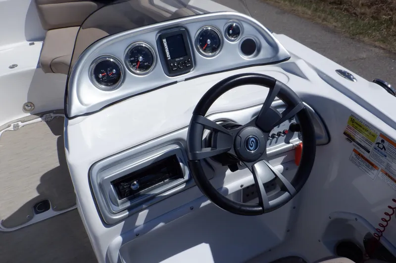 Slide: The Image of 2014 Hurricane SunDeck Sport 203 OB boat dashboard with steering wheel and gauges. - 39