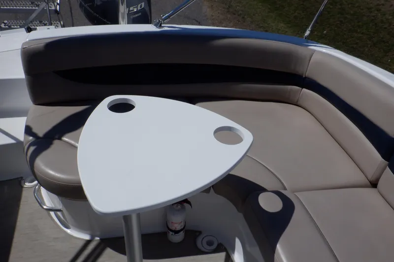Slide: The Image of 2014 Hurricane SunDeck Sport 203 OB boat interior with cushioned seating and a triangular table. - 42