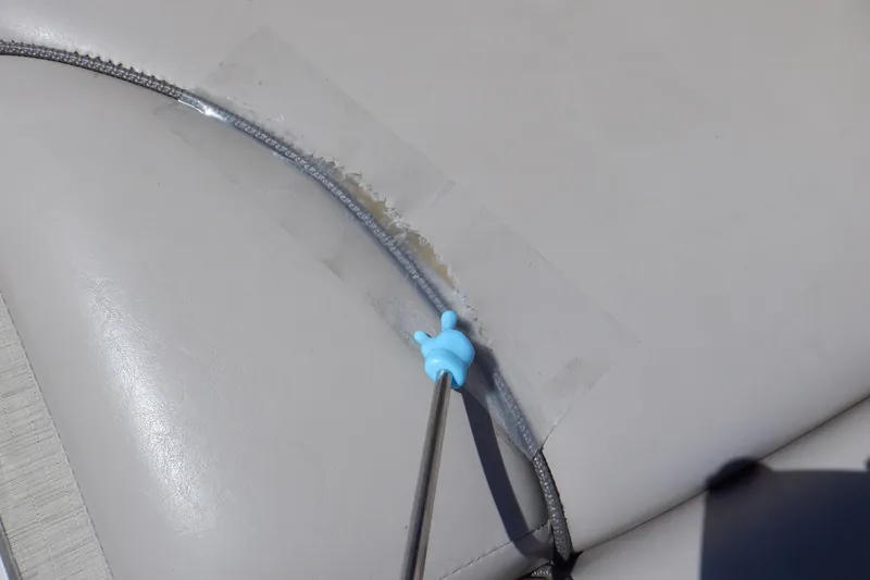 Slide: The Image of Close-up of a 2014 Hurricane SunDeck Sport 203 OB seat with a repair tool. - 48