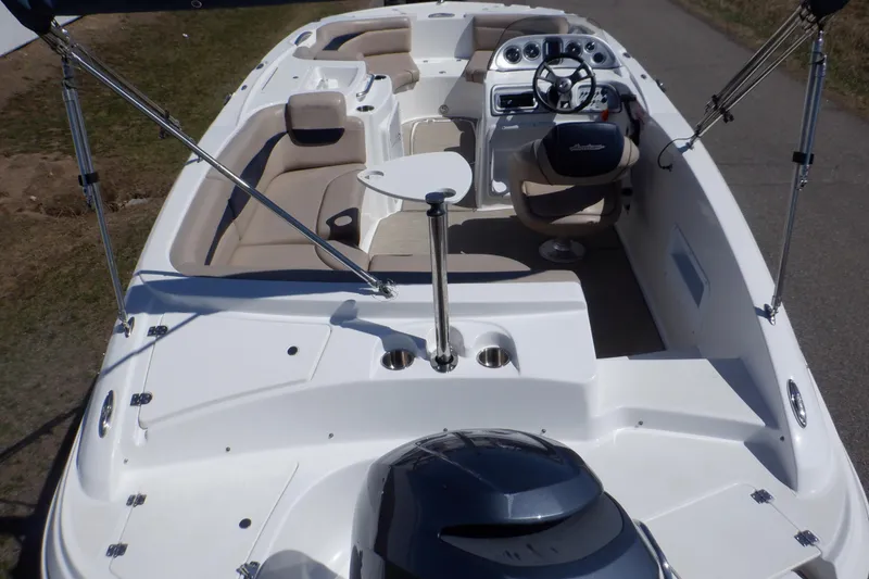 Slide: The Image of 2014 Hurricane SunDeck Sport 203 OB boat with spacious seating and modern dashboard. - 5