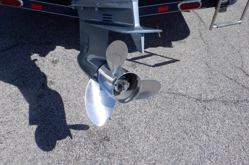 Slide: The Image of 2014 Hurricane SunDeck Sport 203 OB boat propeller on asphalt surface. - 7