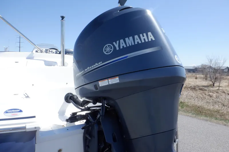 Slide: The Image of 2014 Hurricane SunDeck Sport 203 OB with Yamaha outboard motor, parked outdoors. - 8