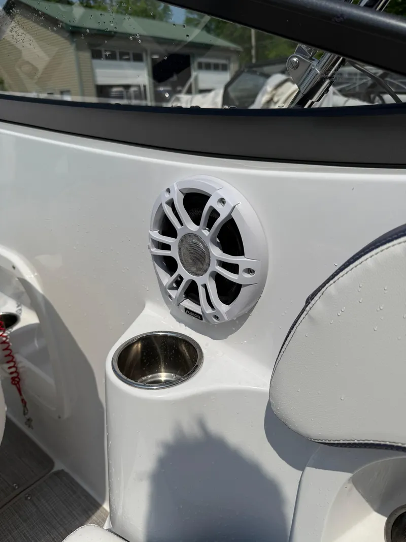 Slide: The Image of 2025 Stingray 211DC boat interior with speaker and cup holder. - 17