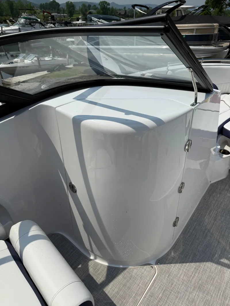 Slide: The Image of 2025 Stingray 211DC boat interior with sleek white design and modern features. - 18