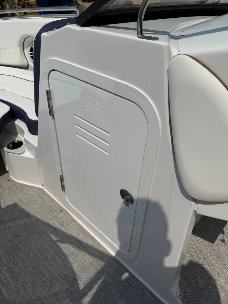 Slide: The Image of 2025 Stingray 211DC boat interior, featuring a sleek storage compartment and comfortable seating. - 22