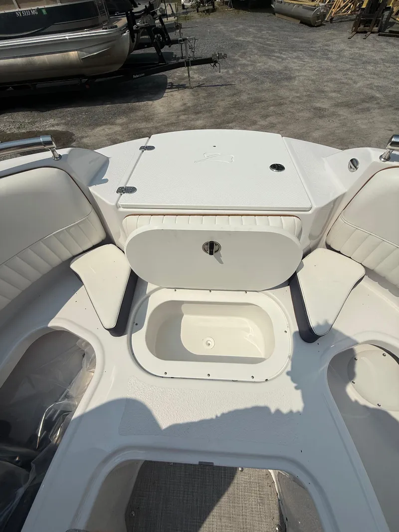 Slide: The Image of 2025 Stingray 211DC boat interior with seating and storage compartments. - 25