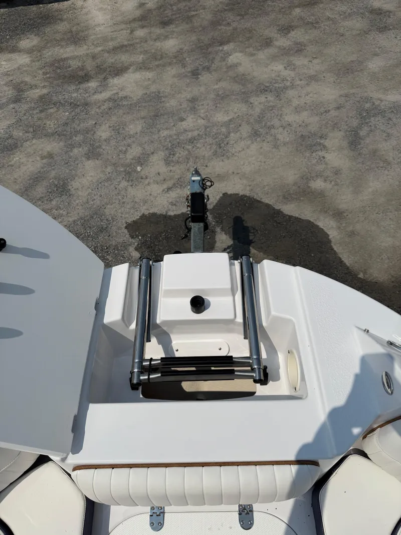 Slide: The Image of 2025 Stingray 211DC boat interior with seating and storage compartments. - 28