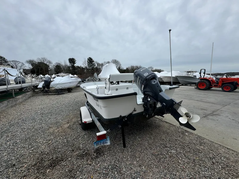 Slide: The Image of 2003 Maritime 1690 boat on trailer, parked outdoors with overcast sky. - 10