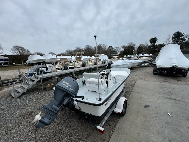 Slide: The Image of Maritime 1690 boat, 2003 model, parked outdoors with other covered boats. - 15