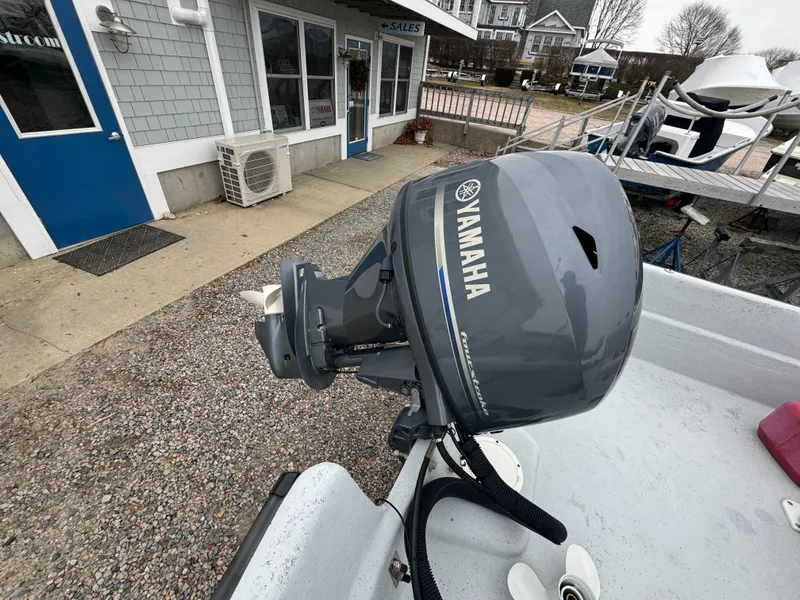 Slide: The Image of Boat with Yamaha outboard motor, Maritime 1690 model, 2003, docked near a building. - 3