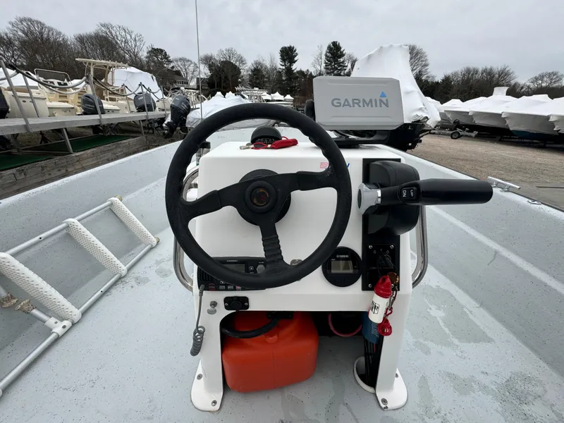 Slide: The Image of Boat steering console with Garmin GPS, Maritime 1690 model, 2003, docked with other boats. - 7