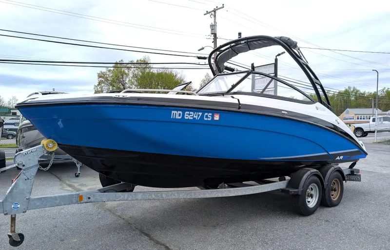 Slide: The Image of 2017 Yamaha Boats AR210 on trailer, blue hull, parked outdoors. - 10