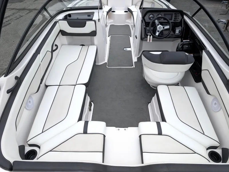 Slide: The Image of 2017 Yamaha Boats AR210 interior with spacious seating and modern dashboard. - 11