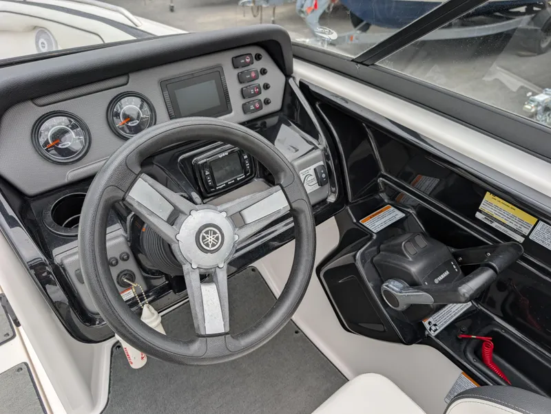 Slide: The Image of 2017 Yamaha AR210 boat dashboard with steering wheel and control panel. - 12
