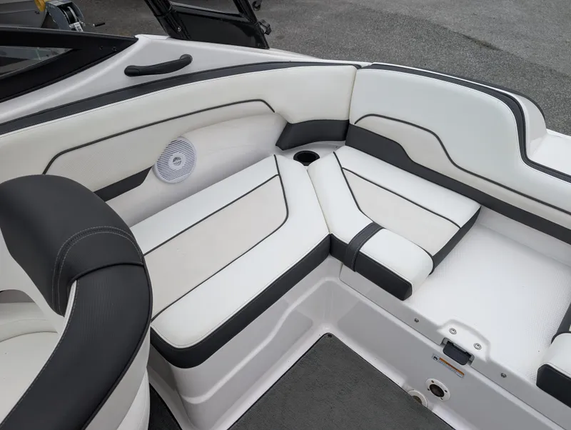 Slide: The Image of 2017 Yamaha AR210 boat interior with white and black seating, speaker, and cup holder. - 14