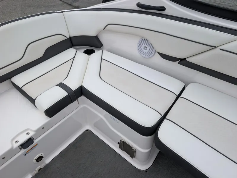 Slide: The Image of 2017 Yamaha AR210 boat interior with white cushioned seating and speaker. - 15