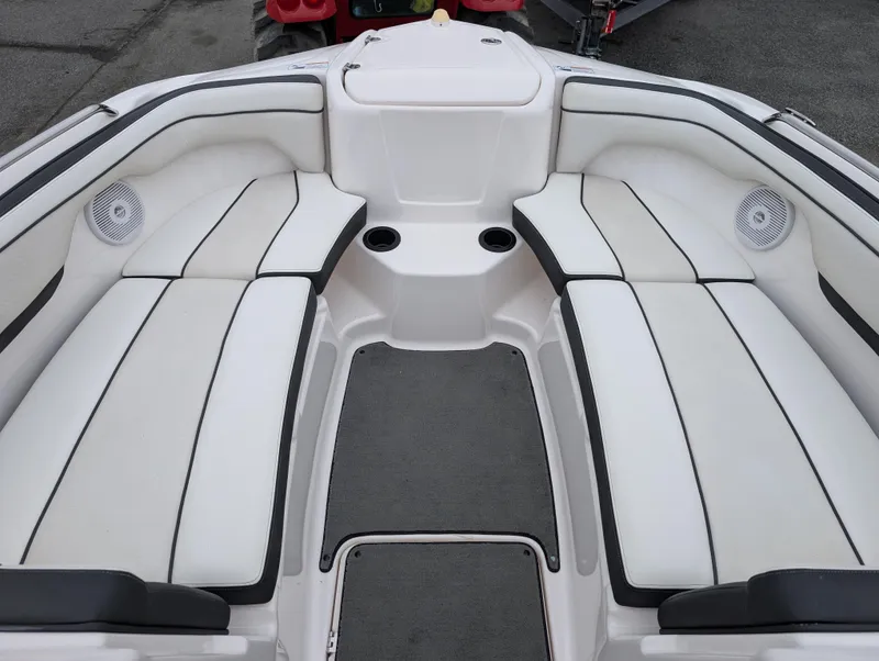 Slide: The Image of 2017 Yamaha AR210 boat interior with white cushioned seating and cup holders. - 17