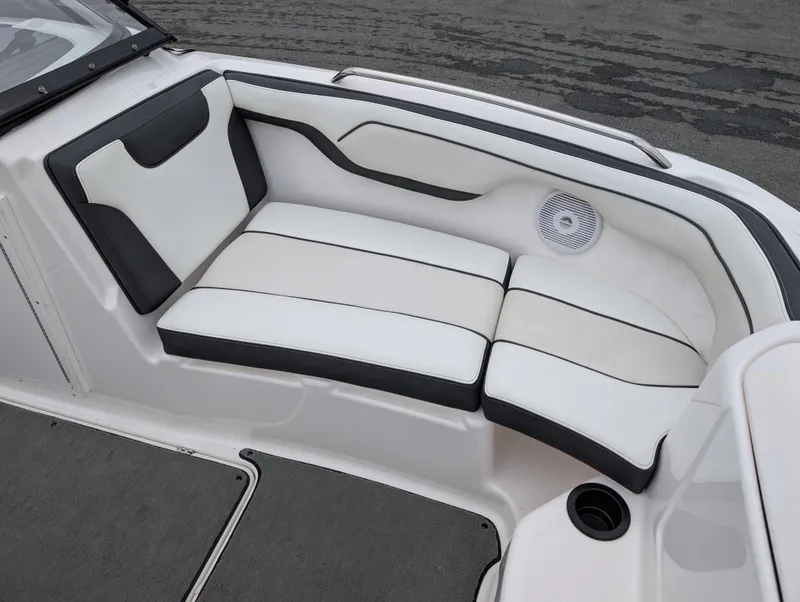 Slide: The Image of 2017 Yamaha AR210 boat interior with white and black cushioned seating. - 18
