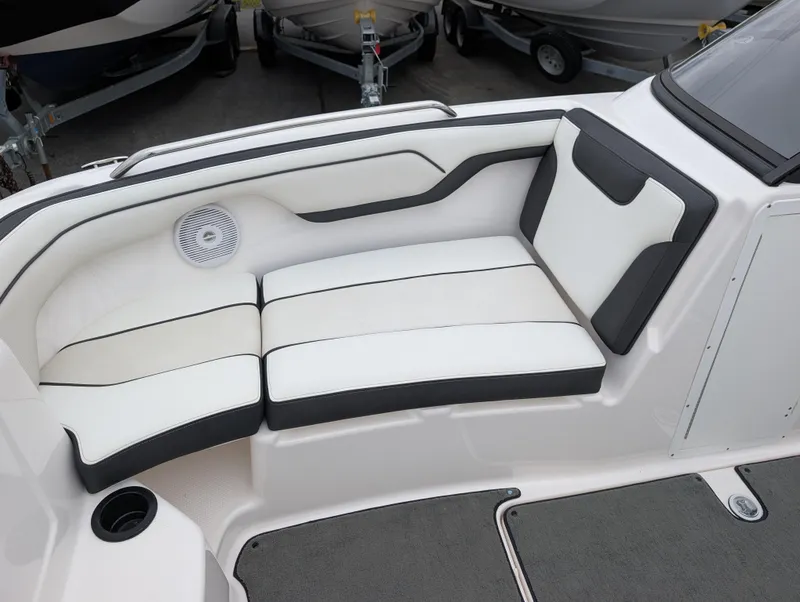 Slide: The Image of 2017 Yamaha AR210 boat interior with white and black cushioned seating. - 19