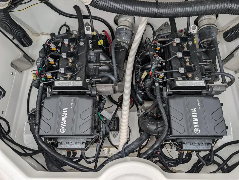 Slide: The Image of Twin engines of a 2017 Yamaha Boats AR210, showcasing intricate wiring and components. - 20