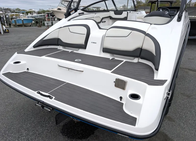 Slide: The Image of 2017 Yamaha Boats AR210, rear view, showcasing sleek design and comfortable seating. - 5