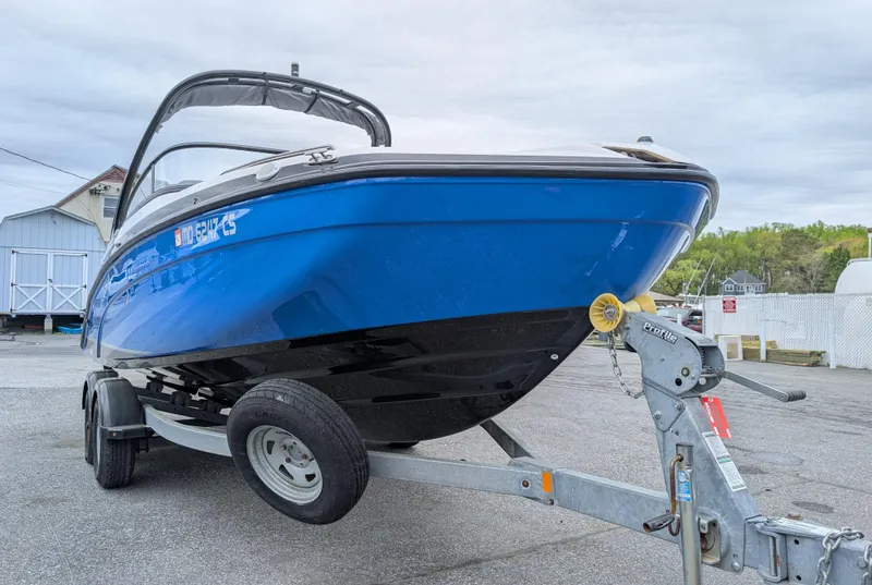 Slide: The Image of 2017 Yamaha AR210 boat on trailer, blue hull, parked outdoors. - 8