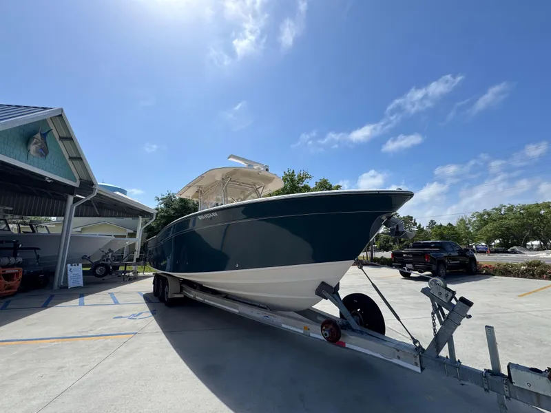 Slide: The Image of 2014 Grady-White Canyon 336 boat on trailer under clear blue sky. - 10