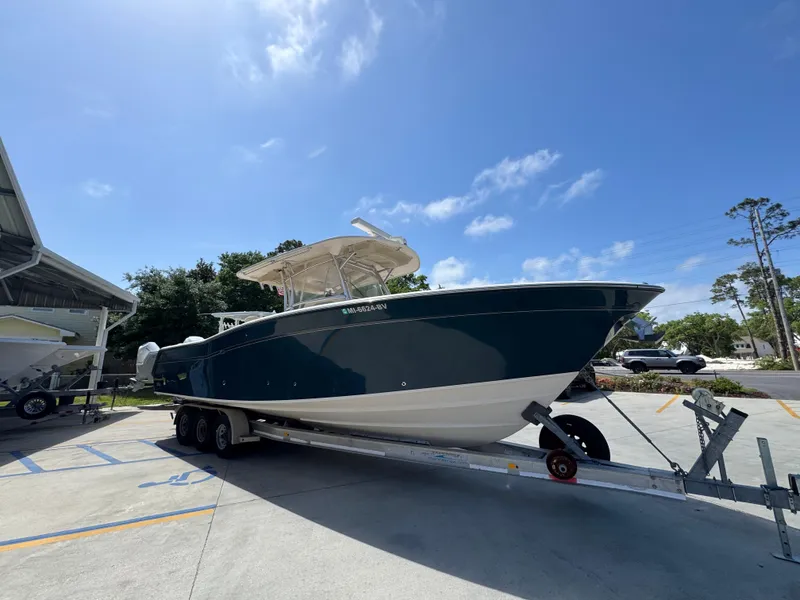 Slide: The Image of 2014 Grady-White Canyon 336 boat on trailer under clear blue sky. - 11